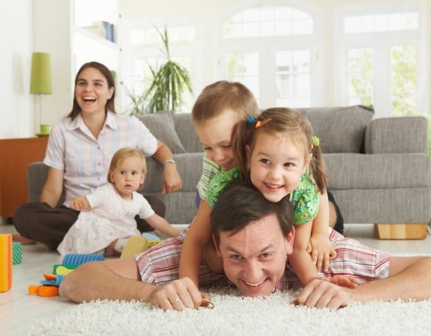 COMFORT family playing in living room shutterstock 53173996 e1445960262492