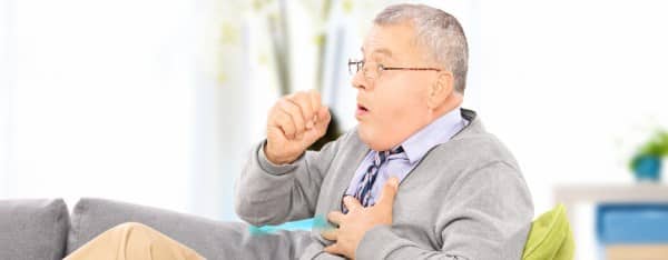 ASTHMA man coughing on the sofa shutterstock 163051682 e1461948329936 cropped3